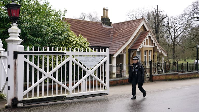 A police officer passes the gate of the Royal Lodge in Windsor fter Andrew Mountbatten-Windsor was arrested by British police on suspicion of misconduct in public office.