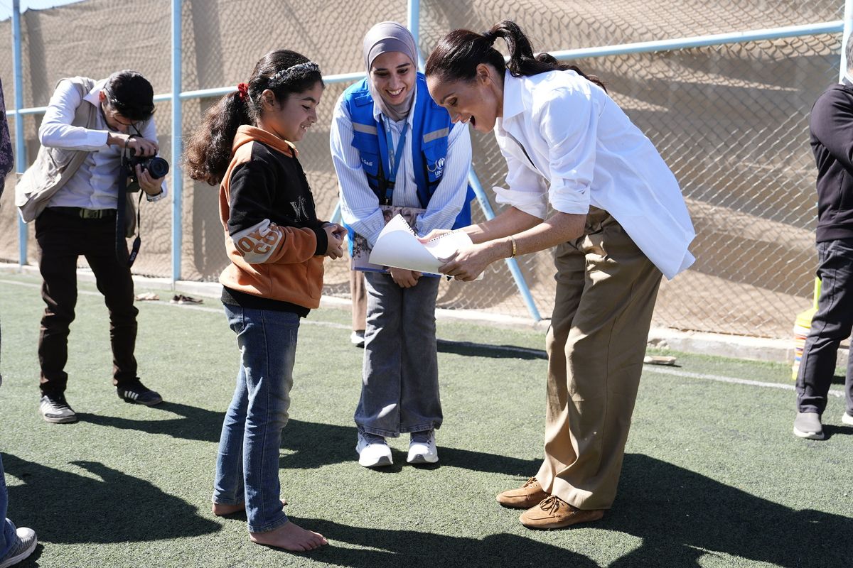 Meghan meeting a girl at an event in Amman