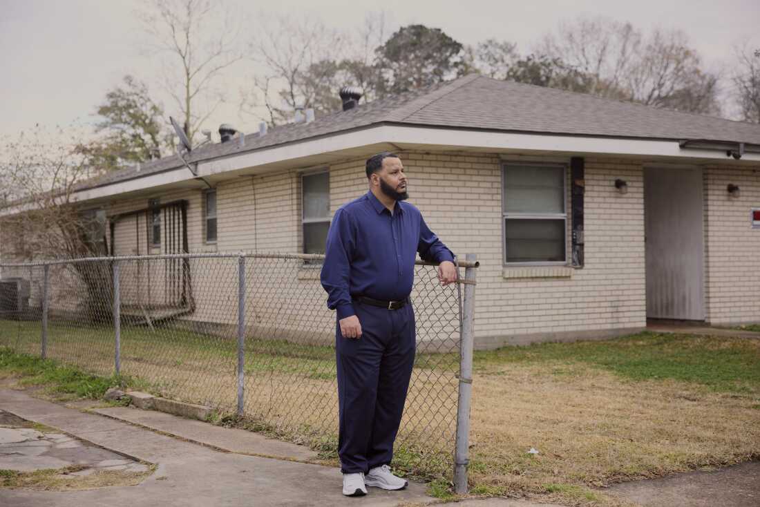 Dustin Vidrine stands outside his house in Lafayette, La.