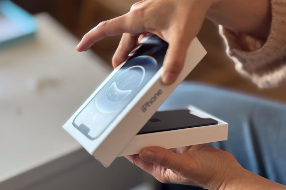 Person unboxing a brand new iPhone 16e