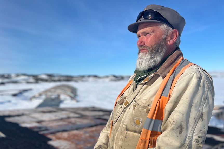 A man stands in an Antarctic environment.