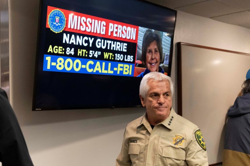 Pima County Sheriff Chris Nanos exits the press room past a missing persons poster after giving an update on the investigation into the disappearance of Nancy Guthrie, in Tucson, Arizona, on February 5.