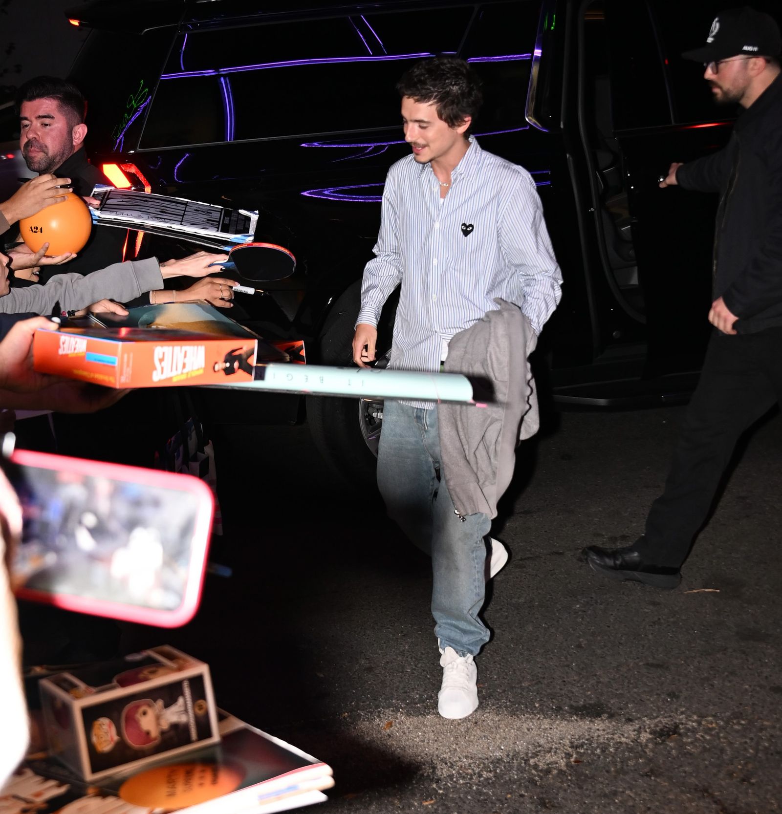 Image may contain Timothe Chalamet Adult Person Urban Clothing Pants Footwear Shoe Car Transportation and Vehicle