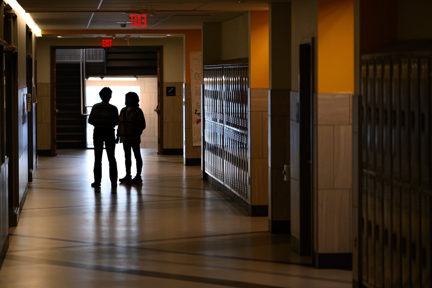 People talk after the school day in a hallway at Somerville High School, on Jan. 21.