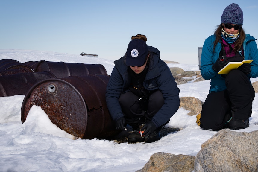 Two people taking samples in the snow.