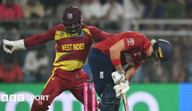 Nepal cricket team players stand beside T20 WC trophy