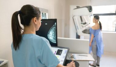 Nurse taking a mammogram exam to an adult patient at the hospital