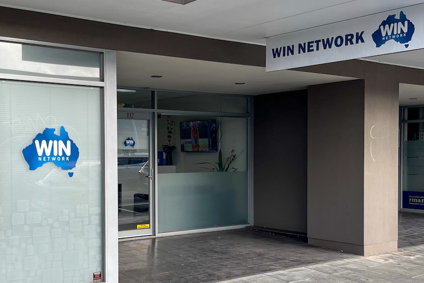 An office building with WIN Network signs out the front