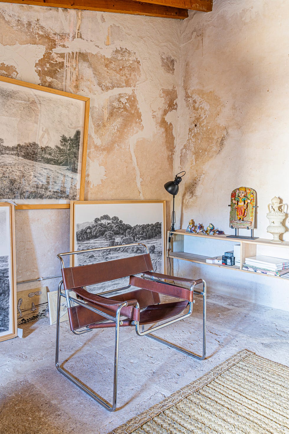 Interior space with a chair and artworks.