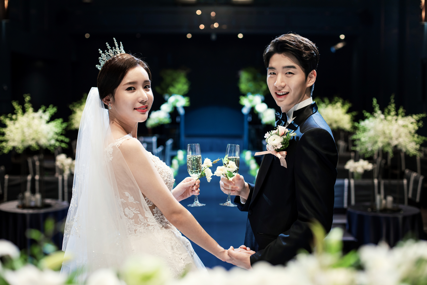 A groom and a bride smile for a photo during a wedding ceremony. [GETTY IMAGES BANK]