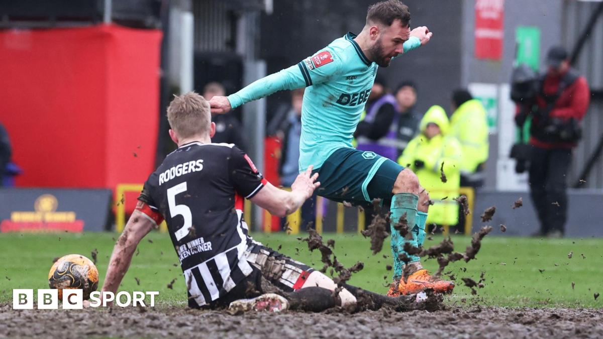Wolves' Adam Armstrong attempts to meet a cross under pressure from Grimsby's Jackson Smith and Harvey Rodgers