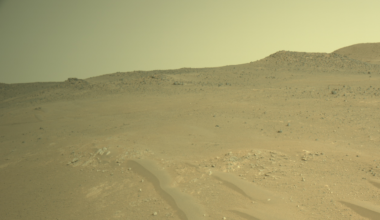 a terrain of red dirt under a reddish-orange sky