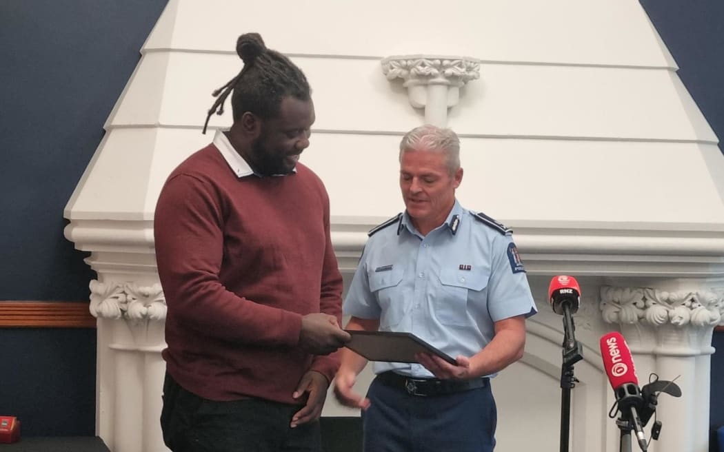 Richard Chambers with Samson Aruwa - helped people on night of deadly pile-up at student flat in Dunedin