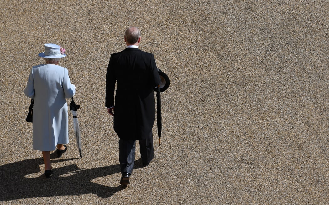 Britain's Queen Elizabeth II (L) and Britain's Prince Andrew, Duke of York, (R) arrive for a garden party in the grounds of Buckingham Palace in central London on May 21, 2019. (Photo by Ben STANSALL / various sources / AFP)