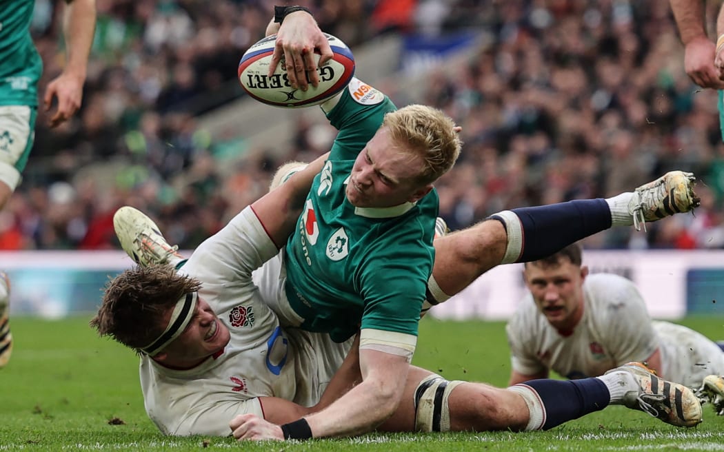 Ireland's full-back Jamie Osborne (C) goes over the line to score a try during the Six Nations international rugby union match between England and Ireland at Allianz Stadium, Twickenham, in south-west London, on February 21, 2026. (Photo by Adrian Dennis / AFP)