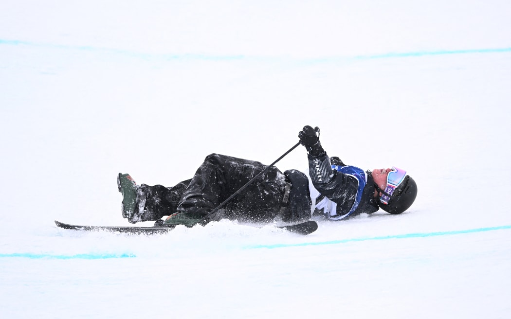 Finley Melville Ives lies on the snow after crashing in the freestyle skiing men's freeski halfpipe qualification run 2 during the Milano Cortina 2026 Winter Olympic Games at Livigno Snow Park, in Livigno (Valtellina), on February 20, 2026.