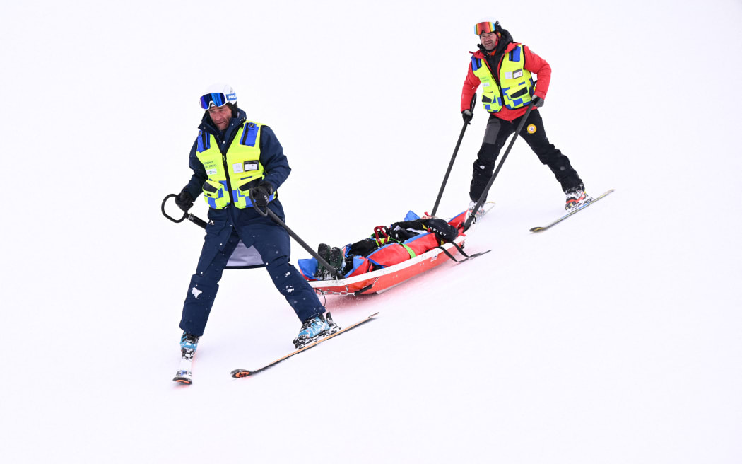 New Zealand's Finley Melville Ives is evacuated by a medical team in the freestyle skiing men's freeski halfpipe qualification run 2 during the Milano Cortina 2026 Winter Olympic Games at Livigno Snow Park, in Livigno (Valtellina), on February 20, 2026.