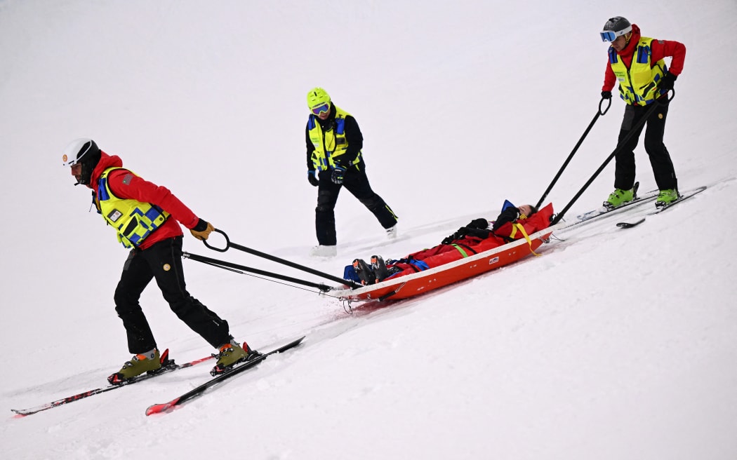 Canada's Cassie Sharpe receives medical assistance after crashing during the women's freestyle skiing halfpipe at the Winter Olympics. 2026.