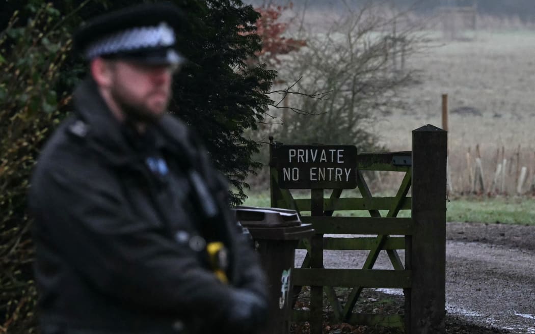 A policeman stands at an entrance to Wood Farm on the royal family's Sandringham Estate in Norfolk, eastern England on February 19, 2026, where former prince Andrew was arrested earlier in the day. Britain's royal family was in crisis on February 19 as former prince Andrew was in police custody after being arrested on suspicion of misconduct for his links to late US sex offender Jeffrey Epstein. (Photo by JUSTIN TALLIS / AFP)