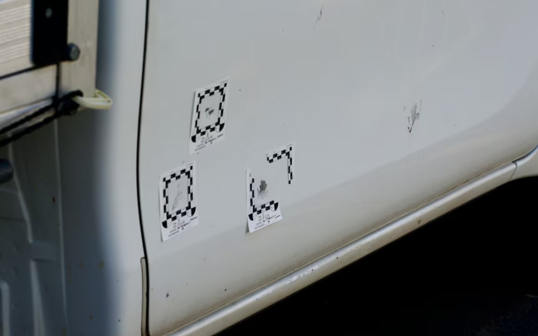 Evidence markers show where gun shots hit a ute at Greenacre. (ABC News: Gavin Coote)