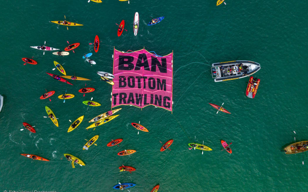 A flotilla of crafts, from fishing boats and yachts to kayaks and stand up paddle boards, surrounding a floating ‘ban bottom trawling’ banner at Mission Bay in Auckland, New Zealand in a show of opposition to bottom trawling in the Hauraki Gulf marine park. Hundreds of people turned out on the beach and on the water for the event organised by Greenpeace Aotearoa and Forest & Bird. Over 60 vessels joined the flotilla.