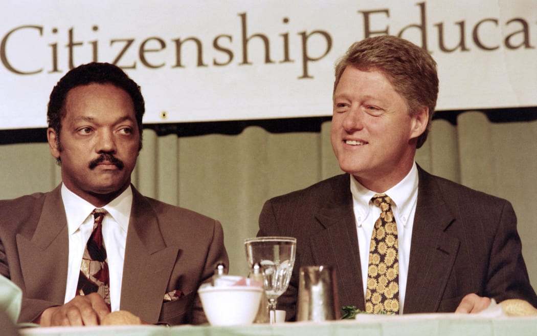 Democratic Presidential hopeful Bill Clinton (R) sits with Jesse Jackson during a luncheon at the national conference "Rebuild America... 92 and Beyond" sponsored by Jackson's National Rainbow Coalition on June 13, 1992.