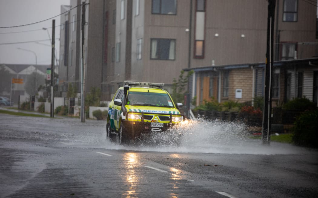 Emergency vehicles making their way through flooded roads in Wellington.