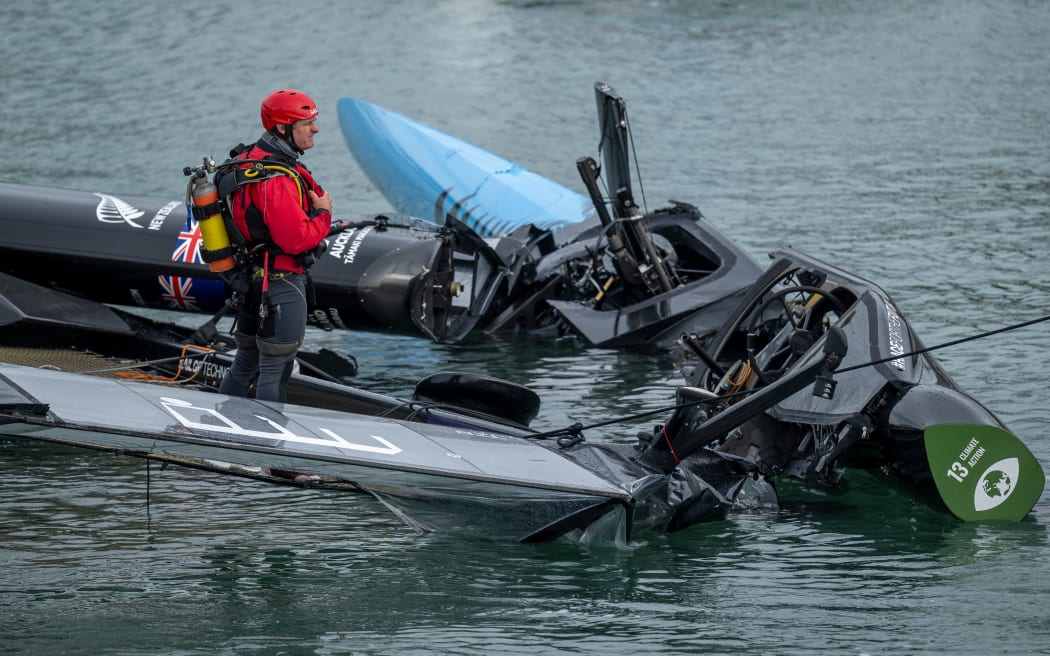 Members of the salvage team works to clear the wreckage following a collision between Team France and Black Foils at the New Zealand Sail Grand Prix in Auckland, 2026.