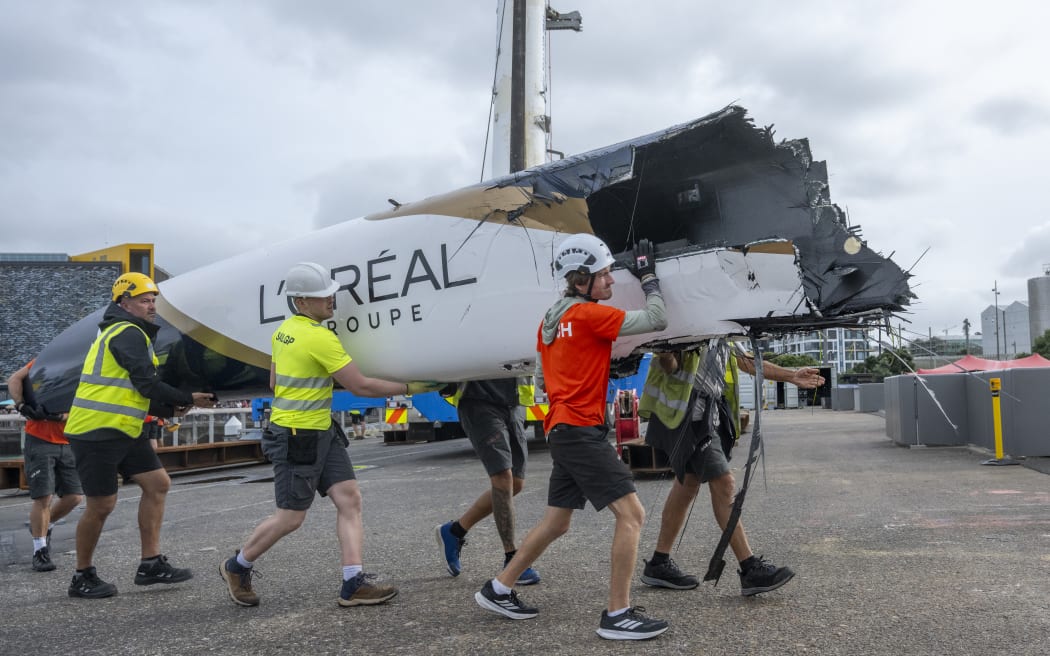 Wreckage from the DS Automobiles SailGP Team France F50 catamaran is moved in the technical area after a collision with Black Foils SailGP Team during racing on Race Day 1 of the ITM New Zealand Sail Grand Prix in Auckland, New Zealand. Saturday 14 February 2026. Rolex SailGP Championship Event 2 2026 Season. Photo: James Gourley for SailGP. Handout image supplied by SailGP