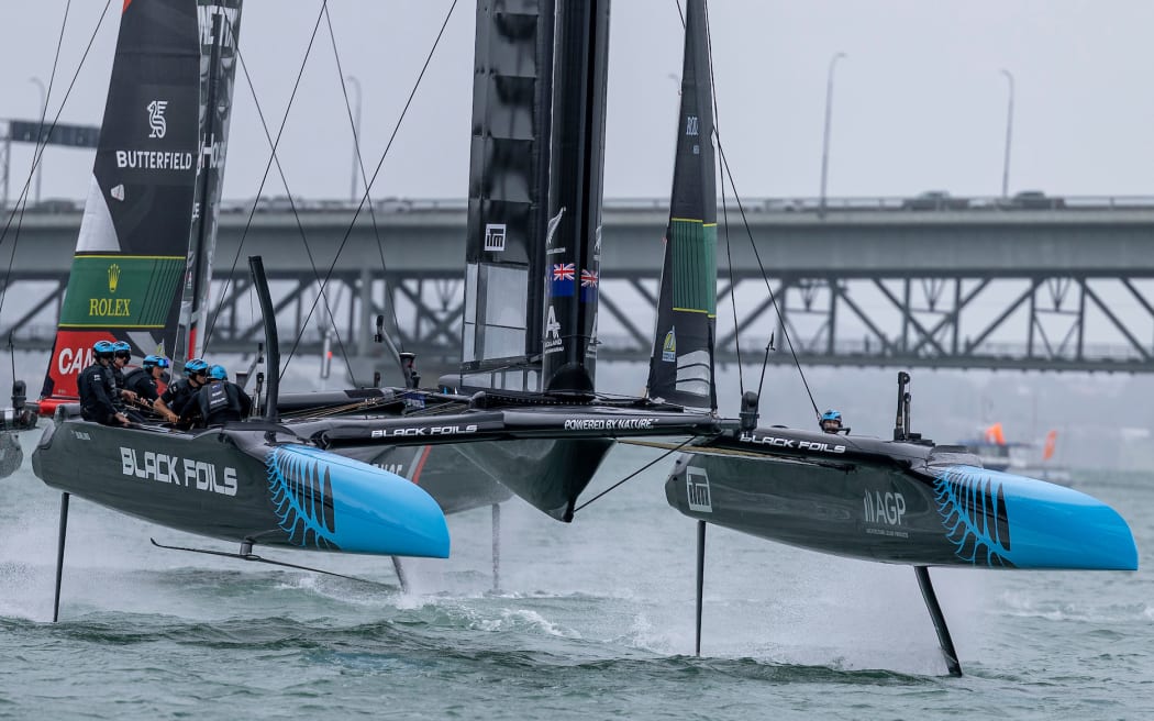 The Black Foils SailGP Team helmed by Peter Burling leads the NORTHSTAR SailGP Team helmed by Giles Scott in action on Race Day 1 of the ITM New Zealand Sail Grand Prix in Auckland, New Zealand.