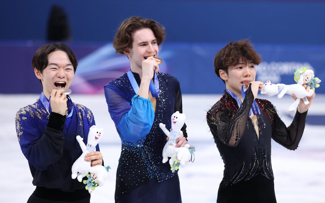 (L-R) KAGIYAMA Yuma of Japan, silver, Mikhail SHAIDOROV of Kazakhstan, gold, and SATO Shun of Japan, bronze, celebrate during the award ceremony for the men's single figure skating at the Olympic Winter Games Milano Cortina 2026 at the Milano Ice Skating Arena in Milan, Italy, on February 13, 2026. Kazakhstan's SHAIDOROV won the event to claim the gold medal. ( The Yomiuri Shimbun ) (Photo by Kaname Muto / The Yomiuri Shimbun via AFP)