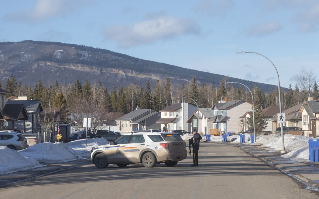 This photograph provided by local journalist Trent Ernst shows a place near the middle school and high school building where a shooting took place, leaving at least nine people dead in the small town of Tumbler Ridge, British Columbia, on February 10, 2026. (Photo by Trent Ernst / AFP) / XGTY / RESTRICTED TO EDITORIAL USE - MANDATORY CREDIT 