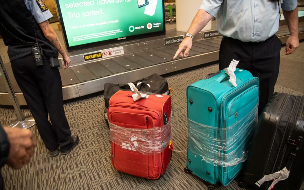 New Zealand Customs officers check luggage at Christchurch Airport.