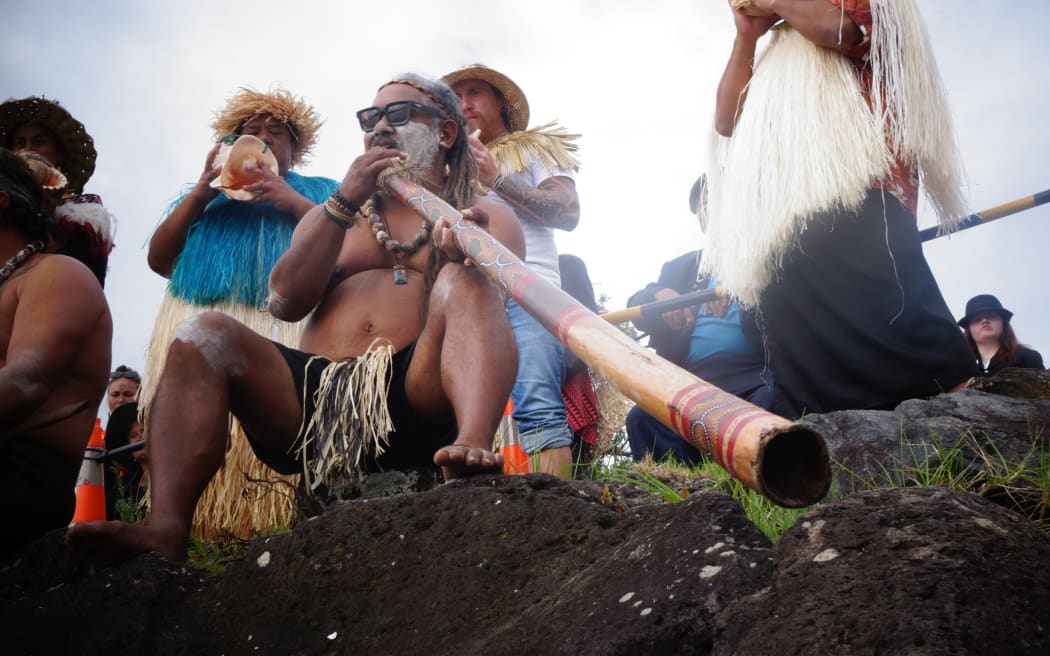 A group representing Pacific, Māori and Aboriginal Australian peoples waited at Te Tii beach to welcome the estimated 700 waka paddlers arriving on Waitangi Morning.