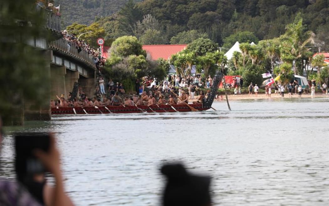 Waka pass under the bridge at Waitangi.