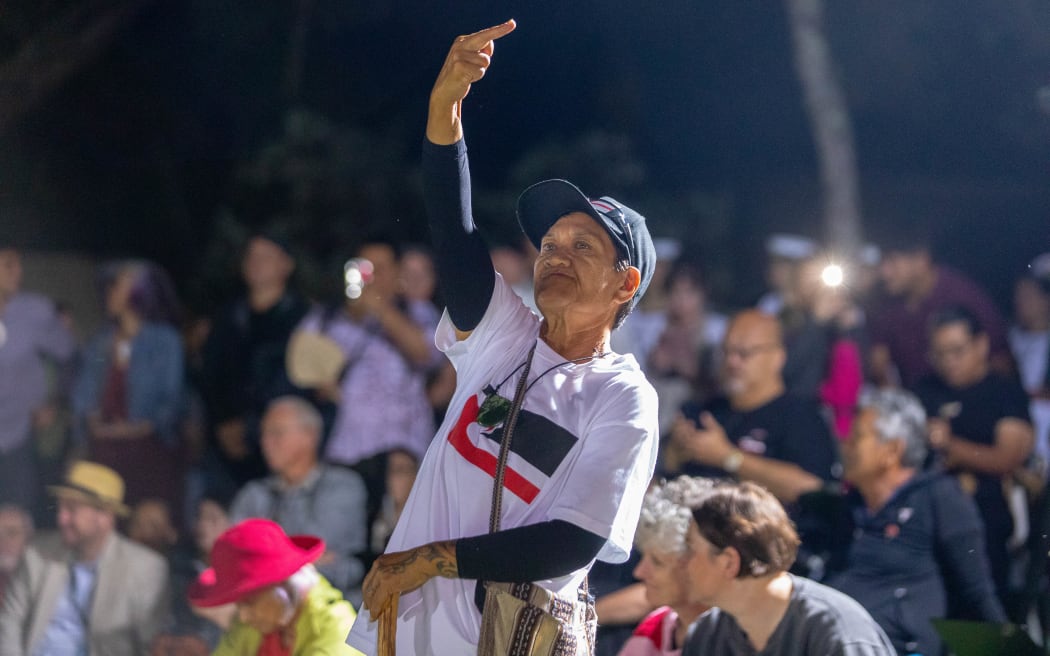 A protestor during deputy prime minister David Seymour's speech at the dawn ceremony at Waitangi Day 2026.
