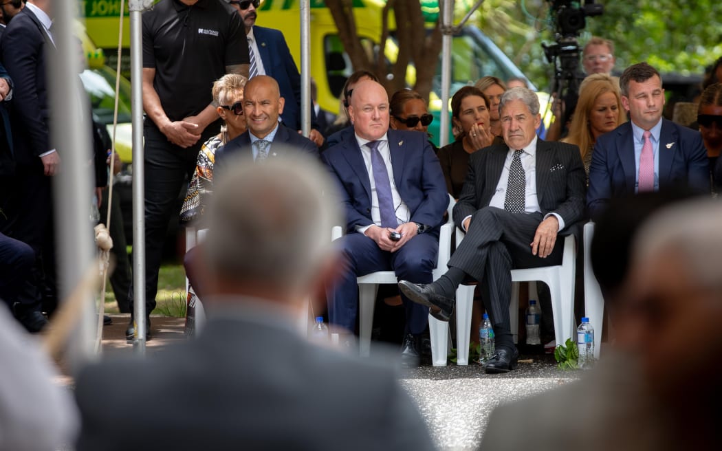 Prime Minister Christopher Luxon sits beside coalition party leaders Winston Peters and David Seymour.