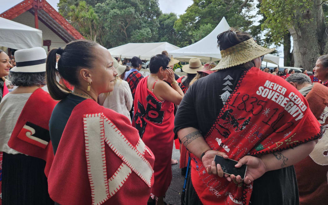 Many people were wearing red blankets emblazoned with words referring to Te Tiriti, whenua and He Whakaputanga.