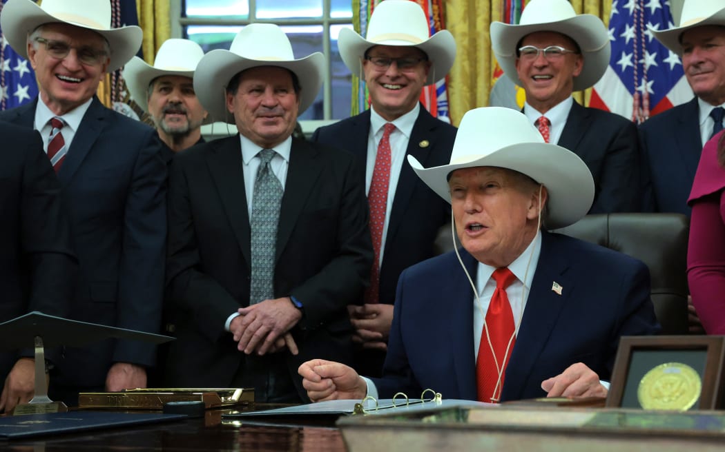 U.S. President Donald Trump wears hat given to him by the 1980 U.S. Olympic men’s ice hockey team as Trump honors the team in the Oval Office of the White House.