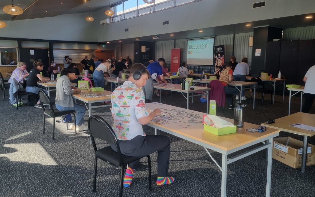 Competitors focus during the jigsaw puzzle racing.