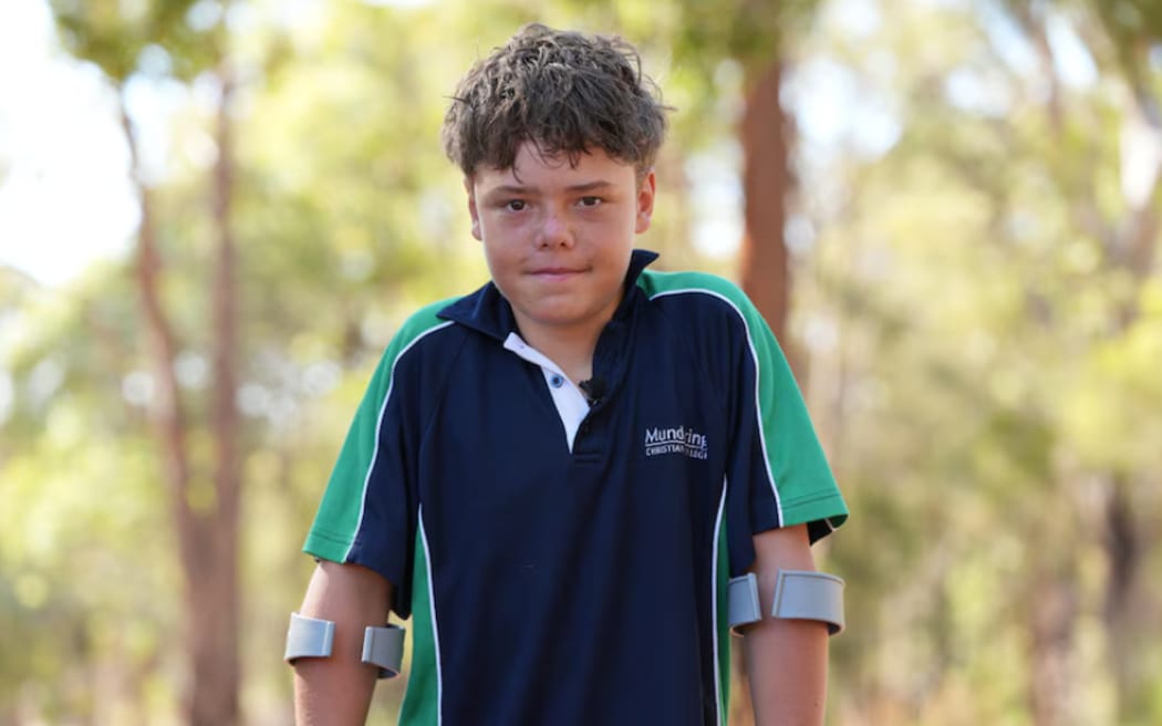 Austin swam 4 kilometres to shore to raise the alarm after being swept out to sea with his mother and siblings.