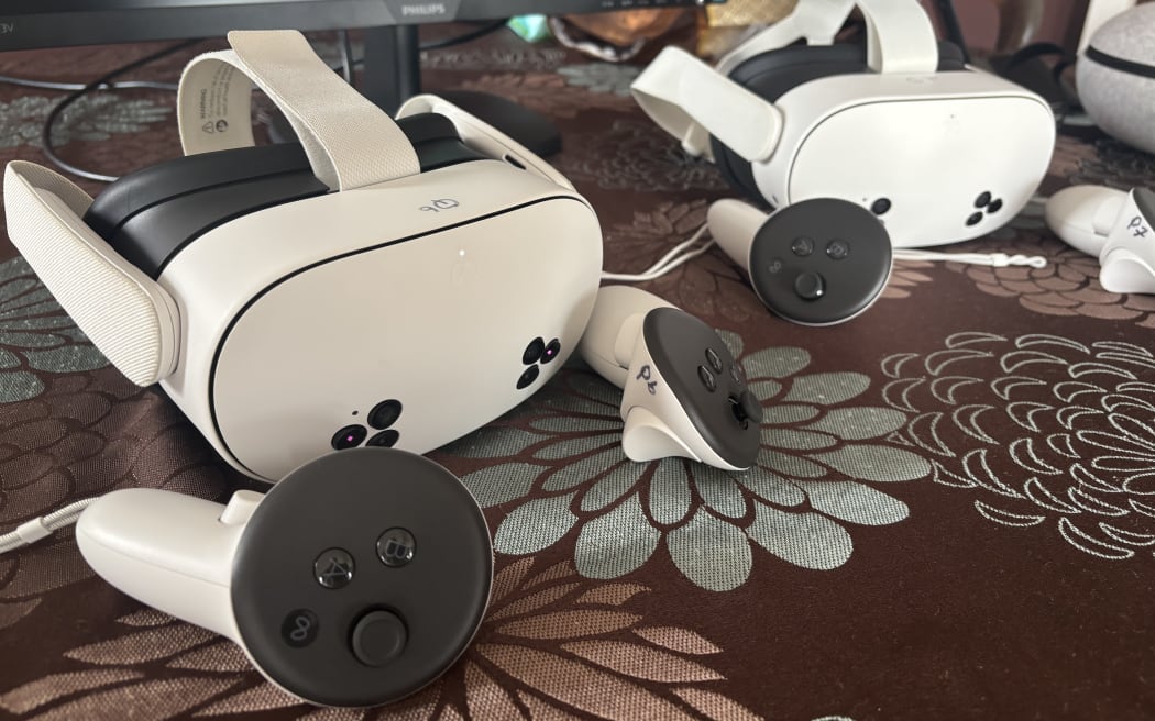 Two virtual reality headsets and sets of controllers