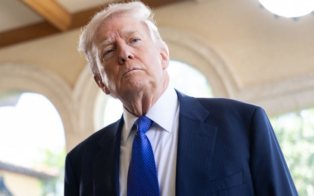 US President Donald Trump speaks to the press as he arrives to attend the wedding of Dan Scavino, White House Deputy Chief of Staff, and Erin Elmore, the Department of State Director of Art in Embassies, at Mar-a-Lago in Palm Beach, Florida, February 1, 2026. (Photo by SAUL LOEB / AFP)