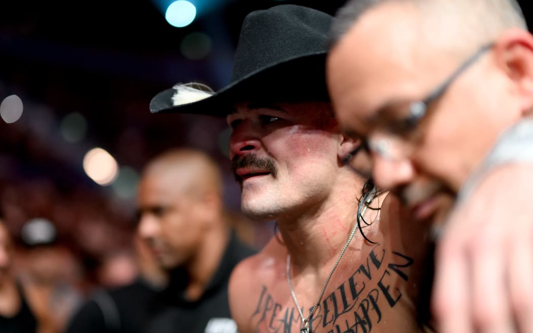 Brazil’s Diego Lopes looks on after losing the men's featherweight division title fight against Australia’s Alexander Volkanovski during the Ultimate Fighting Championship (UFC) 325 at Qudos Bank Arena in Sydney on February 1, 2026. (Photo by STEVEN MARKHAM / AFP) / --IMAGE RESTRICTED TO EDITORIAL USE - STRICTLY NO COMMERCIAL USE--