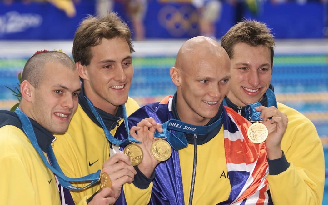 (L to R) Australian Ashley Callus, Chris Fydler, Michael Klim and Ian Thorpe celebrate after winning the gold medal in the men's 4x100m freestyle relay on 16 September 2000 during the Sydney 2000 Olympic Games. The Australians broke the world record with a 3:13.67 time.  AFP PHOTO GREG WOOD (Photo by GREG WOOD / AFP)