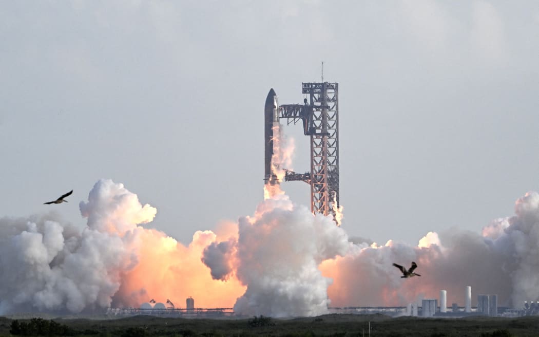 SpaceX's Starship rocket lifts off from Starbase, Texas, as seen from South Padre Island on August 26, 2025, for its tenth test flight. SpaceX's Starship megarocket roared into the skies Tuesday on its 10th test flight, following a string of explosive failures that cast doubt about its ability to realize Elon Musk's vision of colonizing Mars. (Photo by RONALDO SCHEMIDT / AFP)