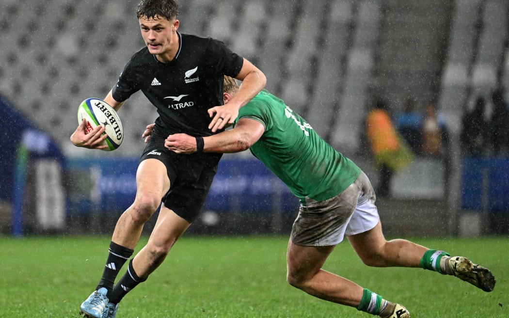 Rico Simpson of New Zealand is tackled by Finn Treacy of Ireland during the 2024 World Rugby U20 Championship 3rd/4th playoff between Ireland and Zealand at Cape Town Stadium in South Africa on 19 July 2024.