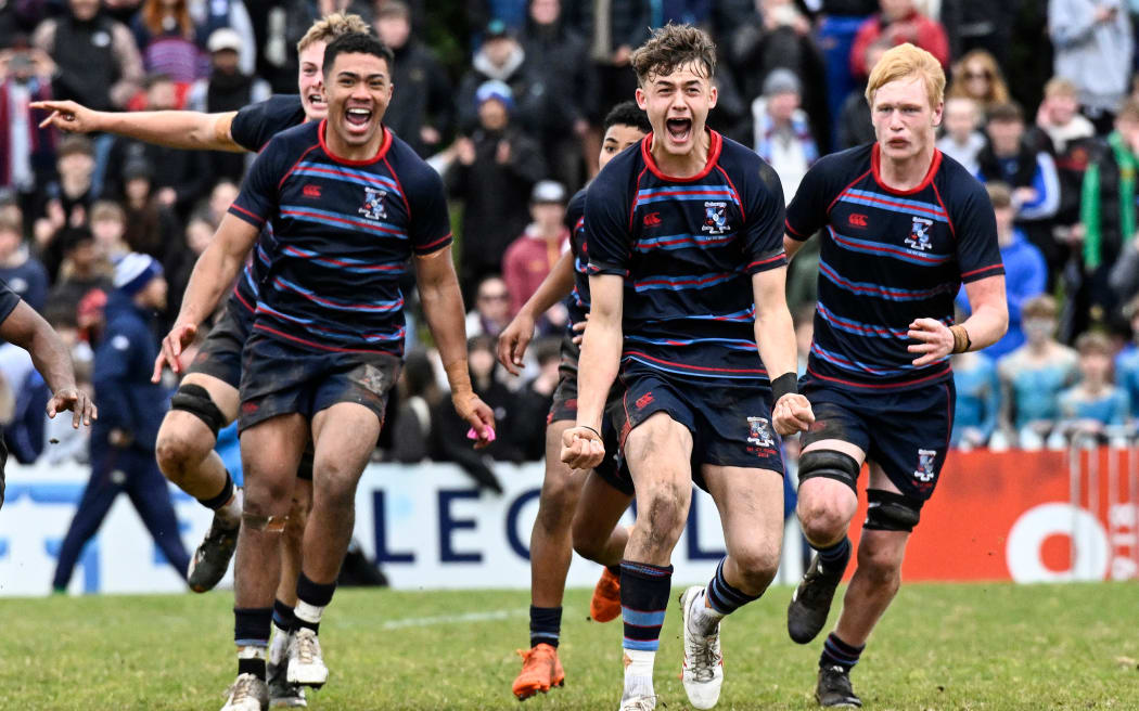 Simpson celebrates with team mates at the final whistle in the First XV Schools Rugby Union 1A Final.