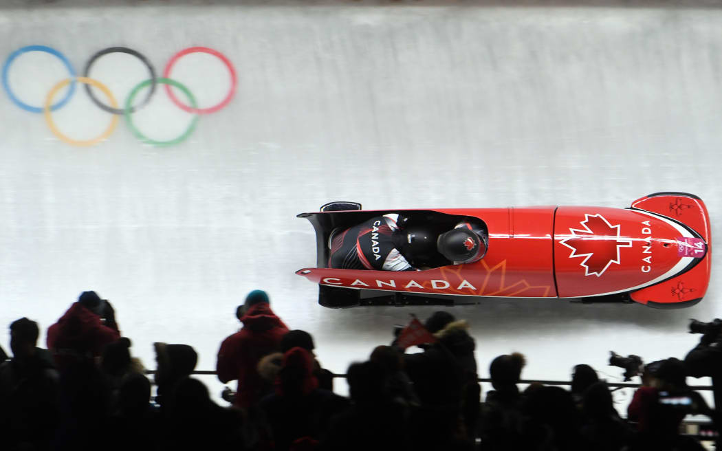 19 February 2018, South Korea, Pyeongchang, Olympics, bobsleigh, two-man seld, 3rd run, Alpensia Sliding Centre: Pilot Nick Poloniato and pusher Jesse Lumsden from Canada