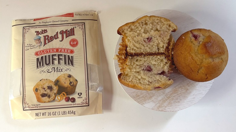 Bag of Bob's Red Mill Gluten Free muffin mix on table next to muffins